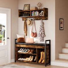 a wooden shelf with shoes and purses hanging on it's side next to stairs