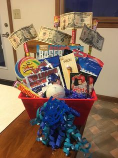 a red basket filled with baseball memorabilia and money