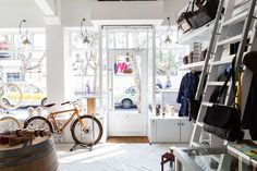 a bike is parked in front of a store with lots of items on the shelves