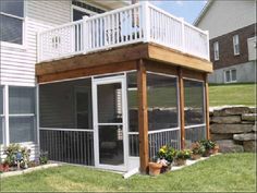 a house with a deck and screened in area