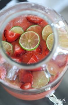 a pitcher filled with watermelon and lime slices