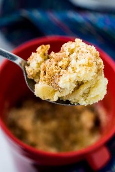 a close up of a spoon in a bowl with some food on top of it