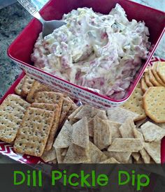 a bowl of dip surrounded by crackers and crackers with the words dill pickle dip