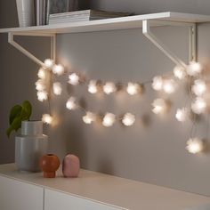 a white shelf with some lights on it