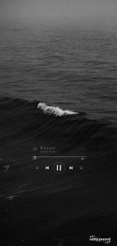 a black and white photo of an ocean wave with the sound player on it's screen