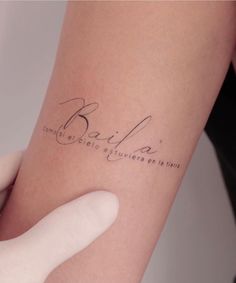 a woman's arm with a tattoo on it that reads, bada and the word