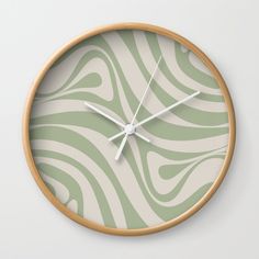 a green and white wall clock with zebra print on the face, in front of a white background