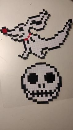 two pieces of paper cut out to look like pixel art