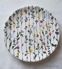 a white plate with flowers painted on it