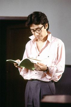 a woman in glasses is reading a book