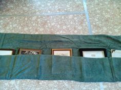 three framed pictures are in the pocket of a green towel