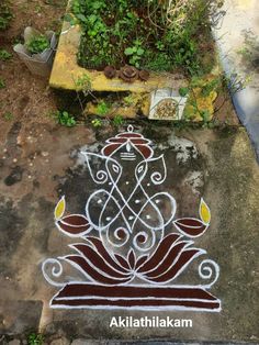 an artistic design on the ground in front of some plants