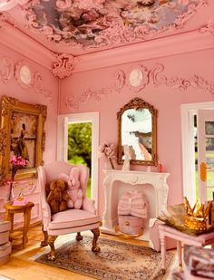 there is a pink room with furniture and decor on the walls, along with a teddy bear