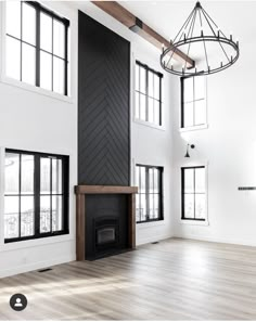 an empty living room with white walls and wood floors