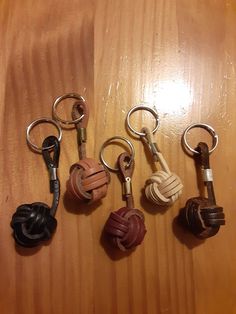 six different key chains on a wooden surface