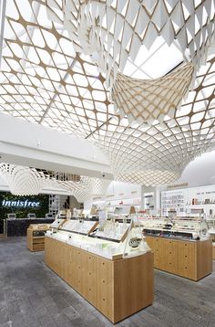 the inside of a store with many items on display and wooden beams hanging from the ceiling