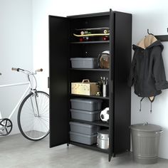 a bike is parked next to a storage cabinet