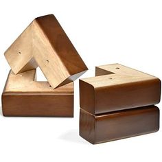 two wooden boxes sitting next to each other on top of a white surface and one has a piece of wood sticking out of it