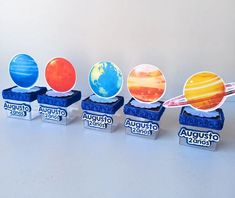 four boxes with different planets on them sitting next to each other