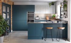 a modern kitchen with blue cabinets and counter tops