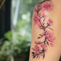 a woman's arm with pink flowers on it