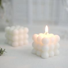 a white candle sitting on top of a table