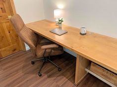 a wooden desk with a laptop on it