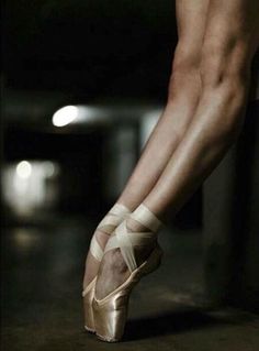 a woman's legs and feet in ballet shoes