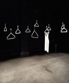 an empty room with clothes hangers on the wall