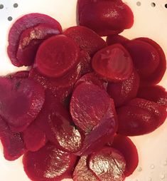 sliced beets in a white bowl on a polka dot tablecloth, ready to be cooked