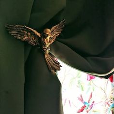 a close up of a curtain with a bird on it