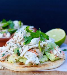 two tortillas topped with chicken salad and garnished with cilantro