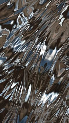 an abstract image of water in brown and blue tones, with the reflection of clouds on it