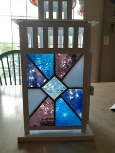 a stained glass window sitting on top of a table