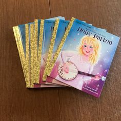 four children's books sitting on top of a wooden table