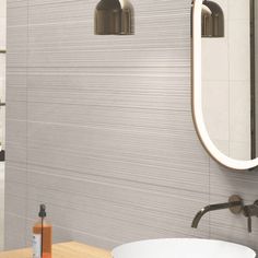 a bathroom sink sitting under a mirror next to a wooden table and white bath tub