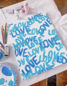 a table topped with blue and white art supplies