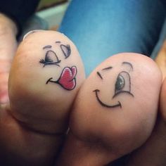 two fingers with faces drawn on them, one has a heart and the other has a nose