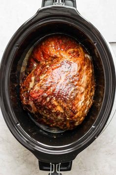 a slow cooked meat in an air fryer with the lid open and ready to be cooked