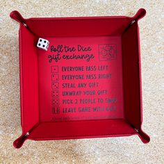 a red box with a dice and some writing on the inside that says, roll the dice off exchange everyone pass left everyone pass right steal any gift