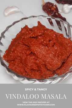 spicy and tangy vindaloo masala in a glass bowl with spoons