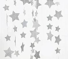 a white curtain with silver stars hanging from it