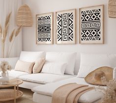 a living room filled with white furniture and art on the wall above it's couches