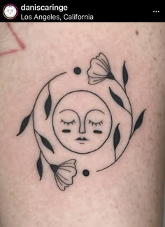 a sun and moon tattoo on the back of a woman's arm, with two butterflies flying around it