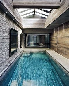 an indoor swimming pool in the middle of a house