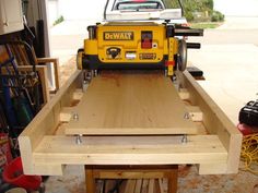 a table sawing in the back of a truck