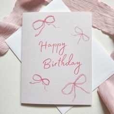 a birthday card with pink bows on it