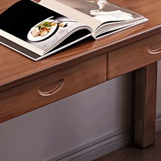 an open book sitting on top of a wooden table