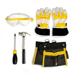 tools are laid out on a white surface including safety glasses, gloves and hammers