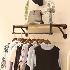 a rack with clothes and hats hanging on it